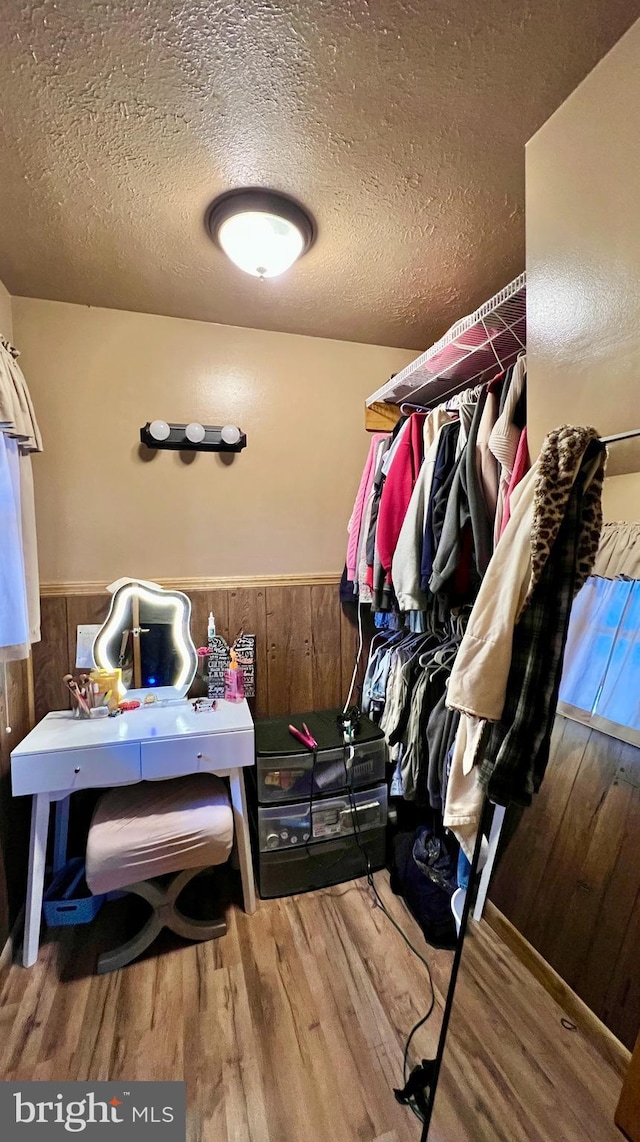 spacious closet with hardwood / wood-style floors