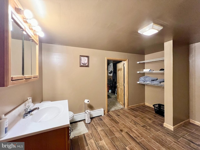 bathroom featuring vanity, a baseboard radiator, and toilet