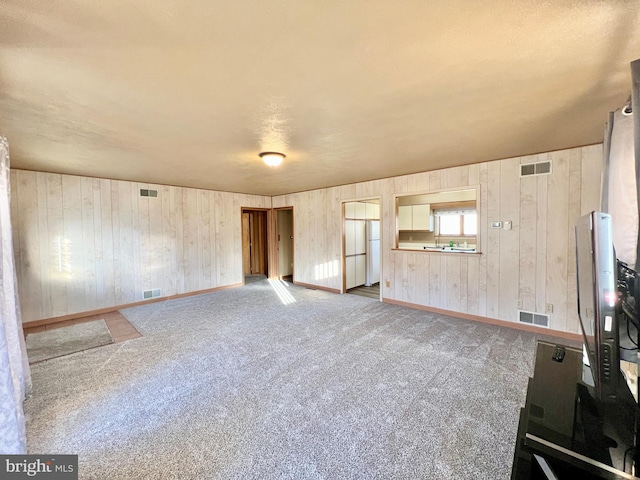 unfurnished living room featuring carpet flooring