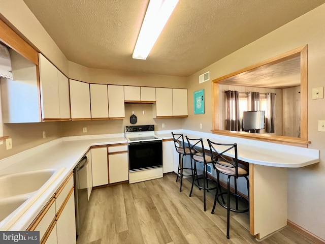 kitchen with white cabinetry, light hardwood / wood-style flooring, electric range, black dishwasher, and kitchen peninsula