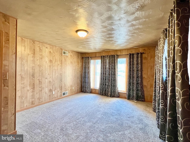 spare room featuring wooden walls