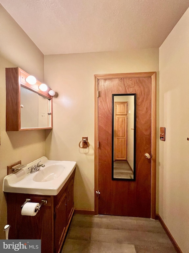 bathroom featuring vanity and a textured ceiling