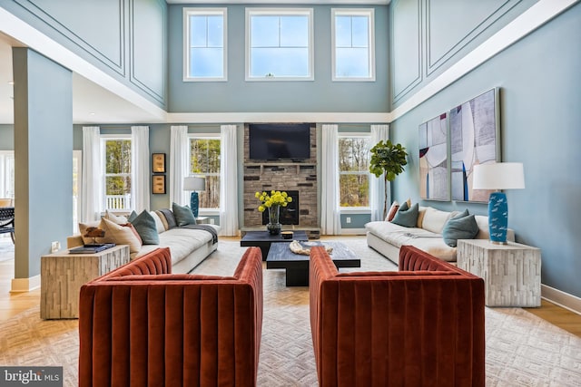 15700 Bennington Farms Ln, Brandywine, MD 20613 - living room featuring a high ceiling, a fireplace, and light hardwood / wood-style flooring