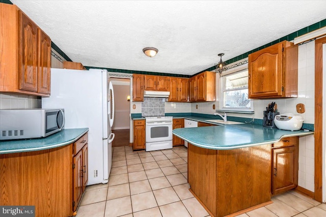 kitchen featuring white appliances, decorative backsplash, light tile patterned floors, and kitchen peninsula