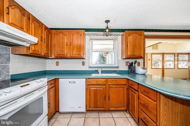 kitchen featuring sink, white appliances, a textured ceiling, and backsplash