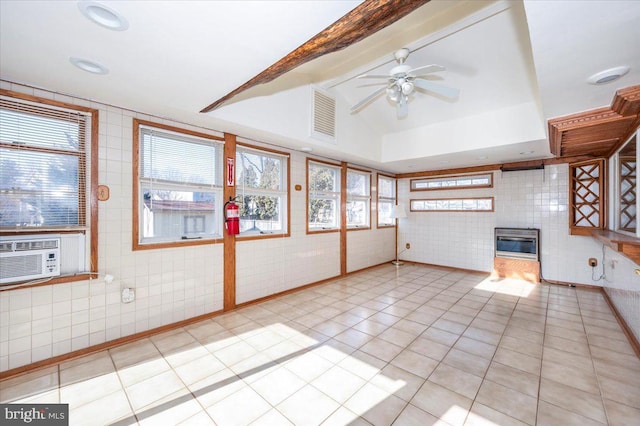 unfurnished living room featuring ceiling fan, light tile patterned floors, vaulted ceiling with beams, and cooling unit