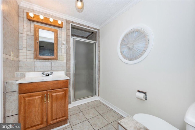 bathroom with ornamental molding, vanity, tile patterned flooring, and a shower with shower door