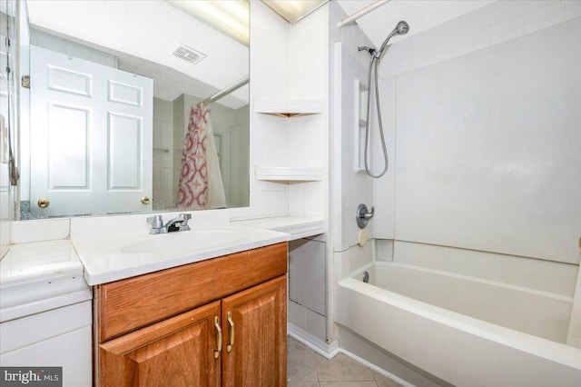 bathroom featuring tile patterned floors, shower / bath combo with shower curtain, and vanity