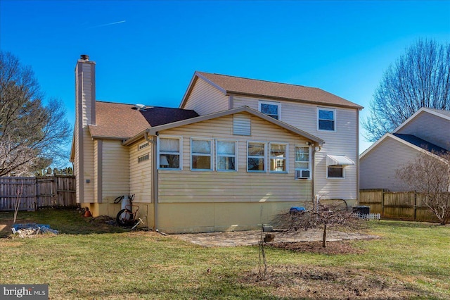 back of house with cooling unit and a lawn