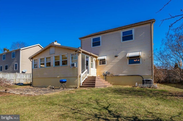 back of property featuring central AC, a patio area, cooling unit, and a lawn