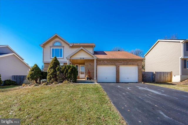 view of property featuring a front lawn and a garage