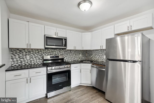 kitchen featuring sink, white cabinets, and appliances with stainless steel finishes