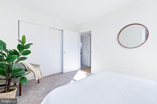 bedroom featuring a closet and light carpet