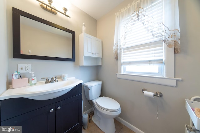 bathroom featuring tile patterned flooring, vanity, and toilet