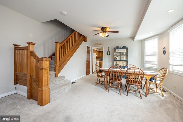 dining room featuring light colored carpet and ceiling fan