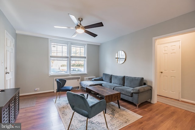 living room featuring ceiling fan, radiator, and hardwood / wood-style floors