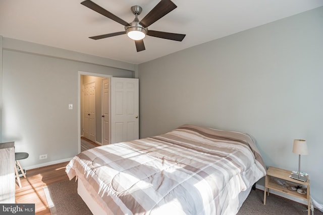 bedroom with ceiling fan and wood-type flooring