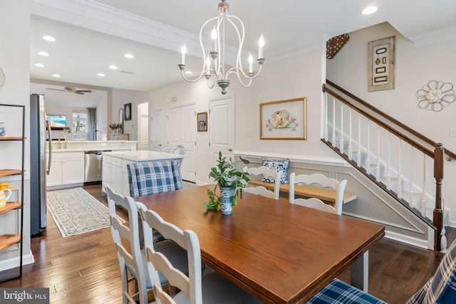 dining area with crown molding, sink, ceiling fan with notable chandelier, and dark wood-type flooring