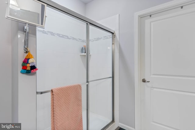 bathroom featuring a shower with door