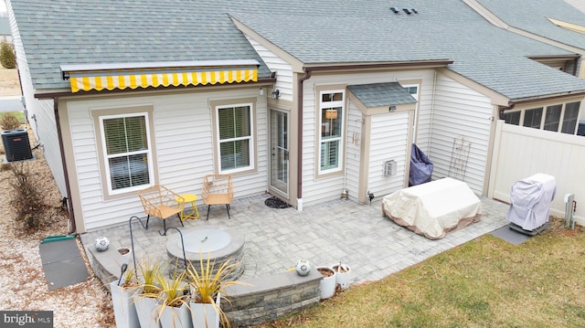 rear view of house featuring cooling unit and a patio