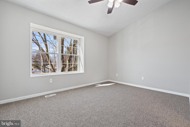 carpeted spare room featuring ceiling fan