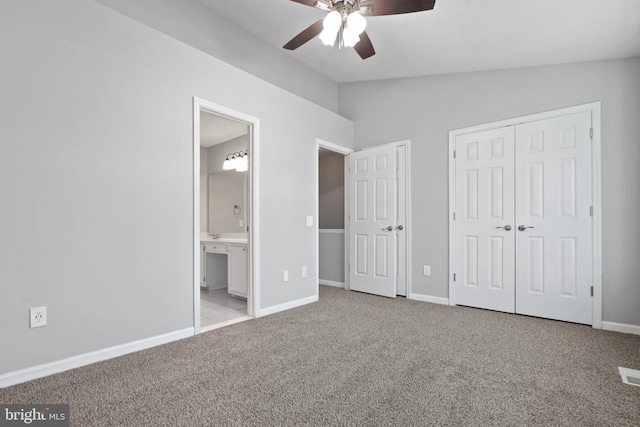 unfurnished bedroom featuring lofted ceiling, light carpet, connected bathroom, and ceiling fan