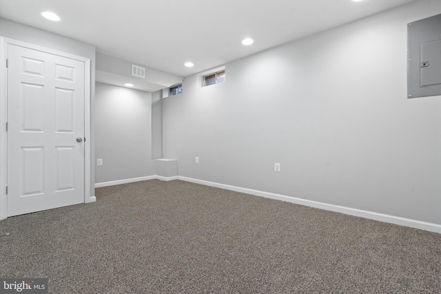 basement with carpet flooring and electric panel