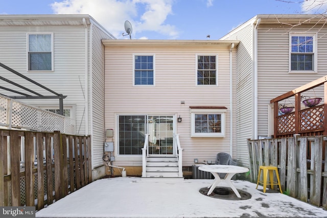 back of house with central AC unit