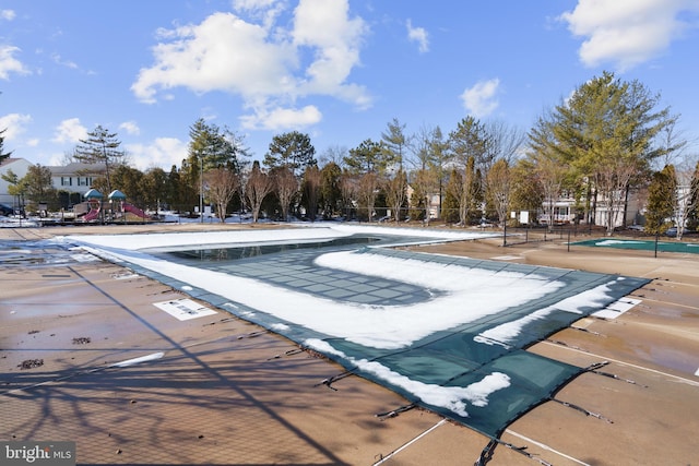 view of swimming pool with a playground