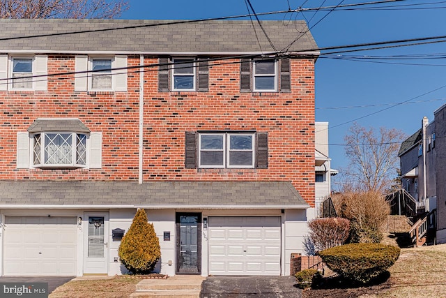 townhome / multi-family property featuring a garage