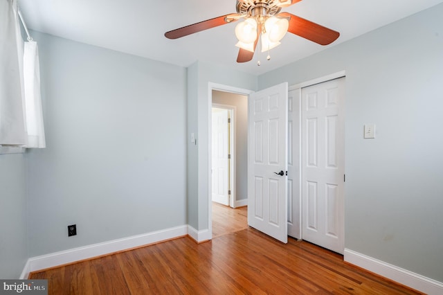 unfurnished bedroom with light hardwood / wood-style flooring, a closet, and ceiling fan