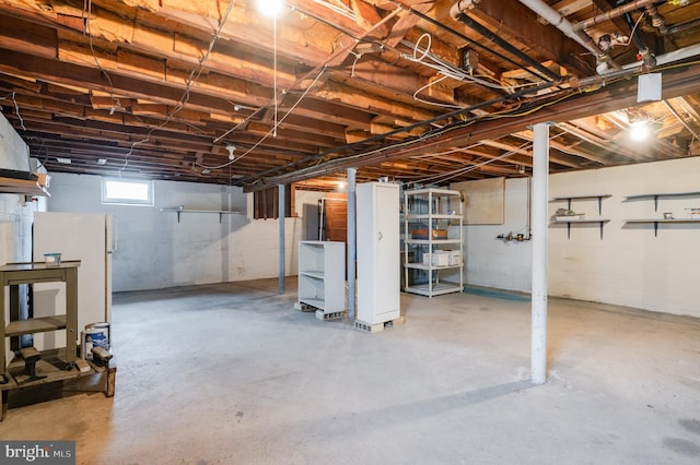 basement with white refrigerator