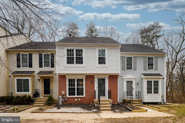 view of front of home featuring a garden and brick siding