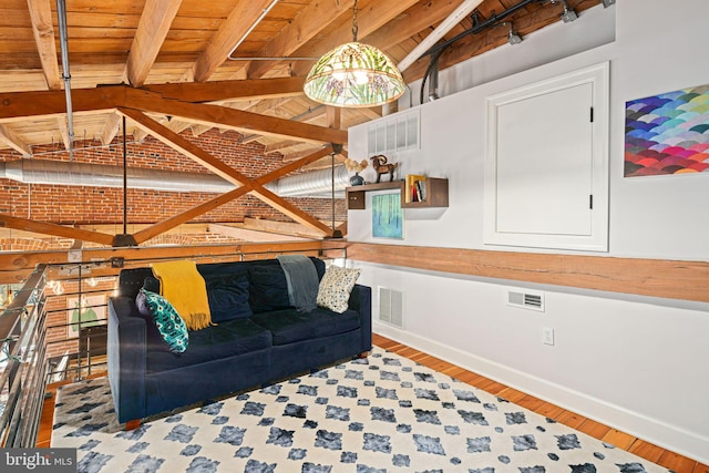 unfurnished living room featuring vaulted ceiling with beams, wood-type flooring, and wooden ceiling