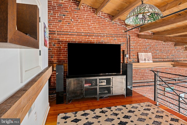 living room with hardwood / wood-style floors, wood ceiling, vaulted ceiling with beams, and brick wall