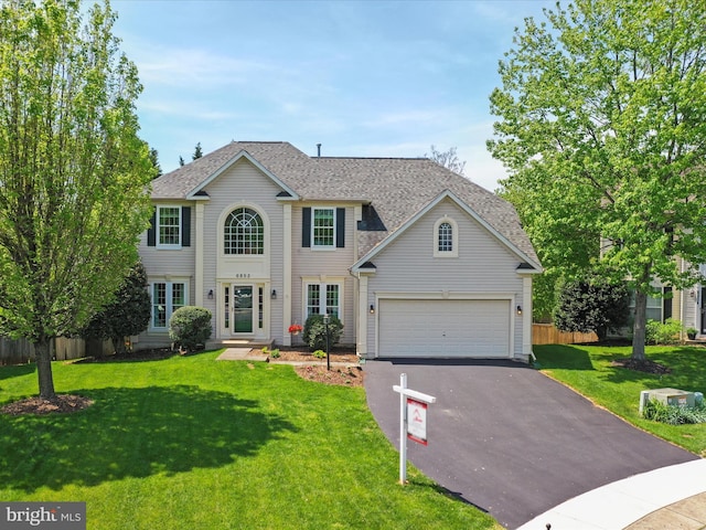 6852 Fielding Ct, Frederick, MD 21703 - view of front of home with a front lawn, aphalt driveway, fence, and roof with shingles