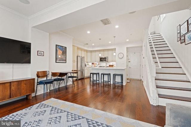 living room featuring crown molding and dark hardwood / wood-style flooring