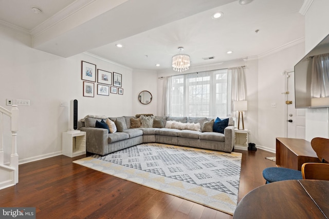 living room with crown molding, dark wood-type flooring, and an inviting chandelier