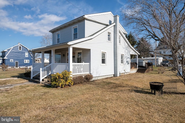 view of property with a front lawn and covered porch