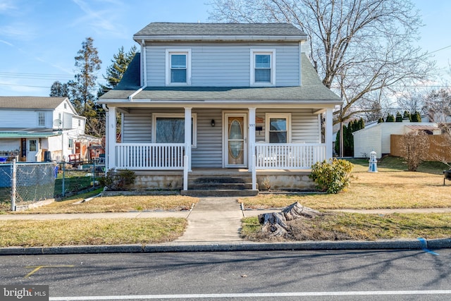 view of front of property with a porch and a front lawn