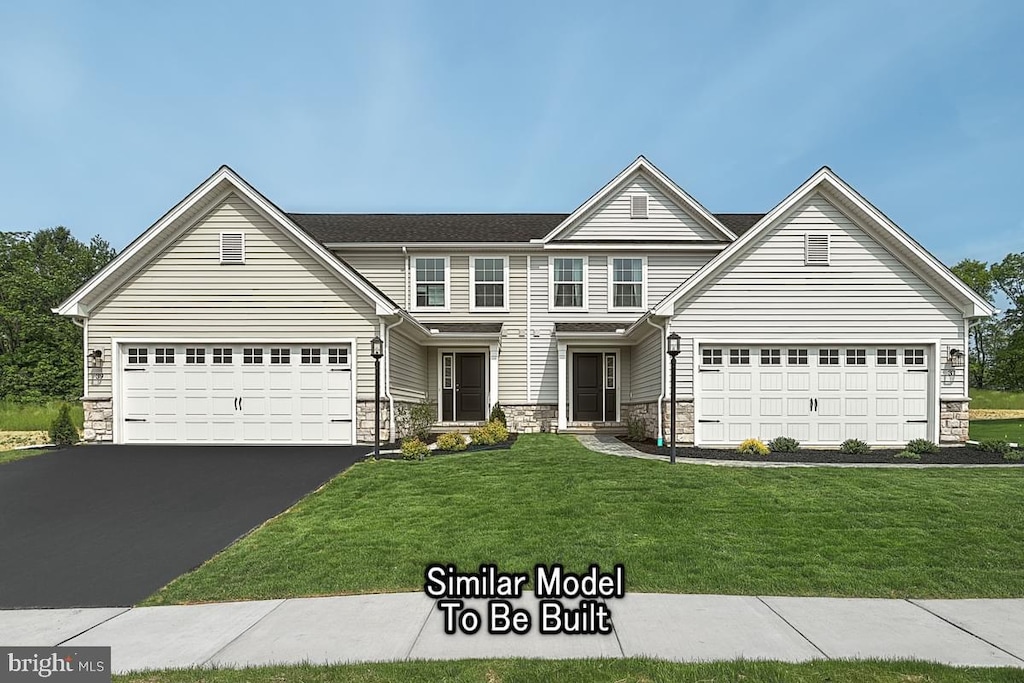 front of property featuring a garage and a front yard