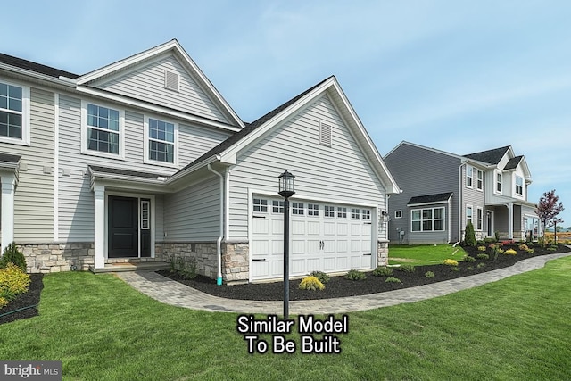 view of front of house with a garage and a front yard