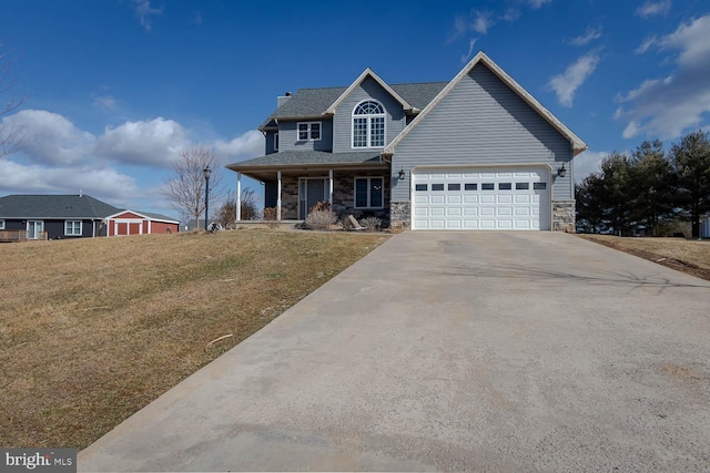 view of front facade with a garage, a front yard, and a porch