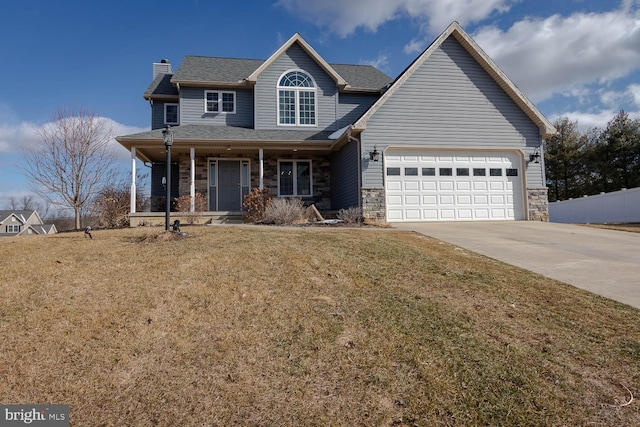 view of front of house with a garage, a front yard, and covered porch