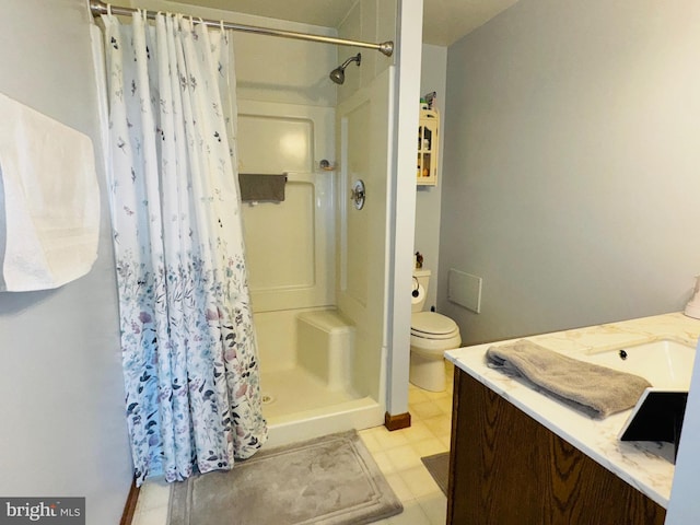 bathroom featuring vanity, toilet, and walk in shower