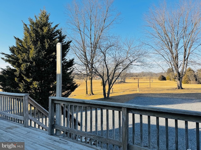 wooden deck featuring a rural view