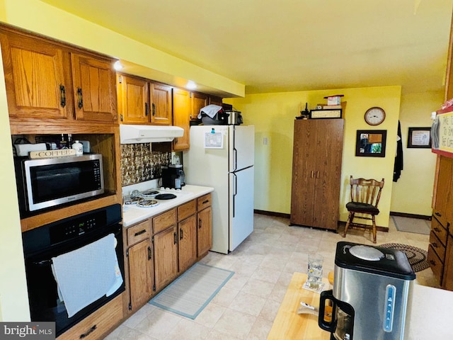 kitchen with tasteful backsplash and white appliances