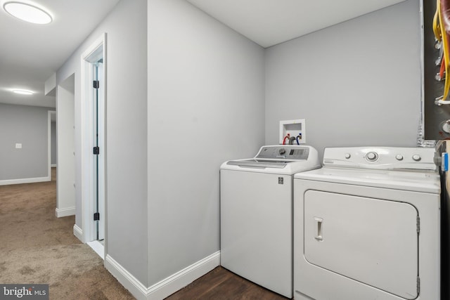 clothes washing area featuring dark colored carpet and independent washer and dryer