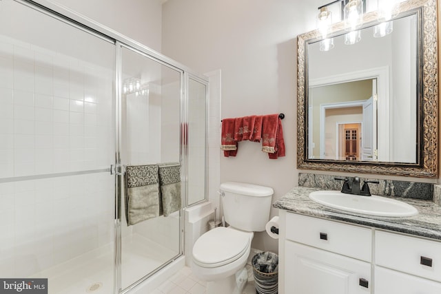 bathroom featuring an enclosed shower, vanity, and toilet