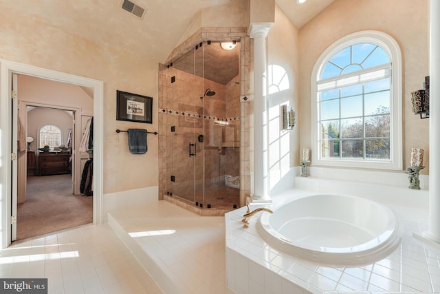 bathroom with decorative columns, vaulted ceiling, independent shower and bath, and tile patterned floors